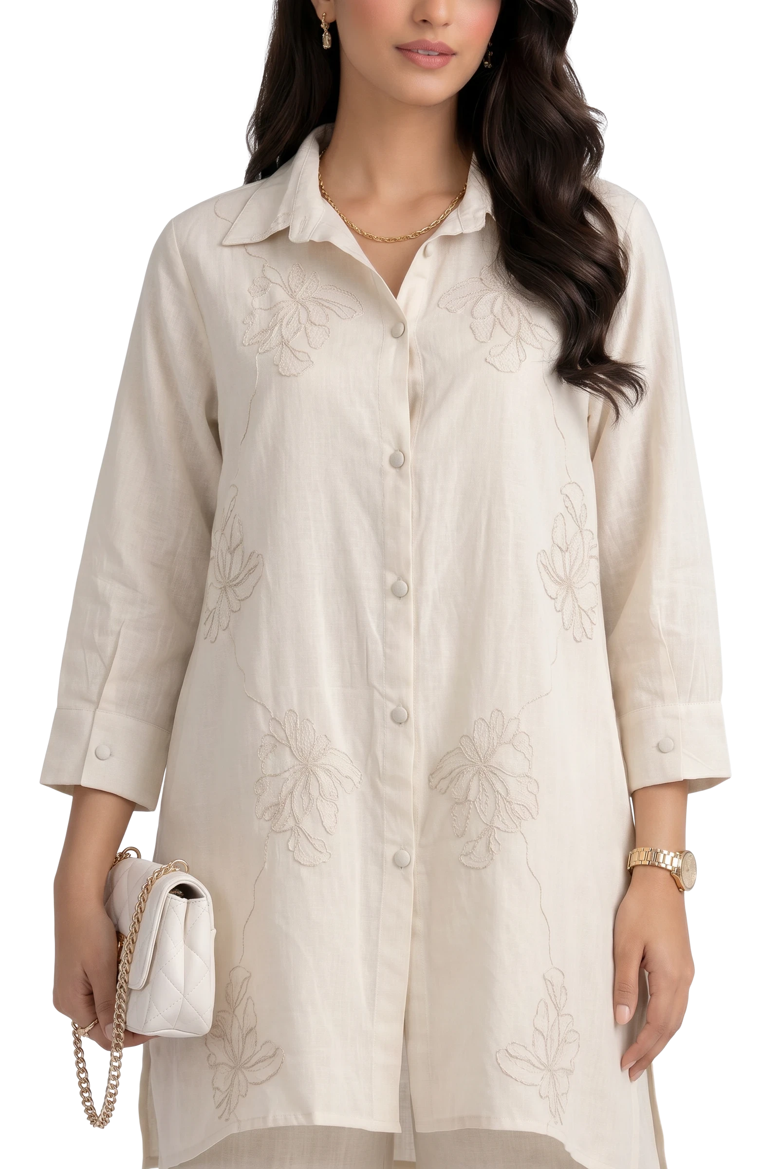 Eclipse The Label cream linen shirt with floral embroidery and palazzo pants. Model wears gold necklace and watch.