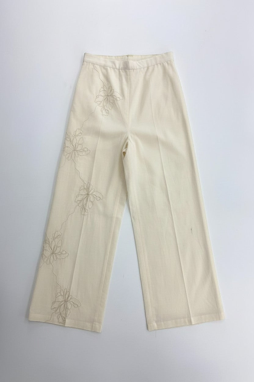 Eclipse The Label cream linen palazzo pants with embroidered floral detail down the side leg.
