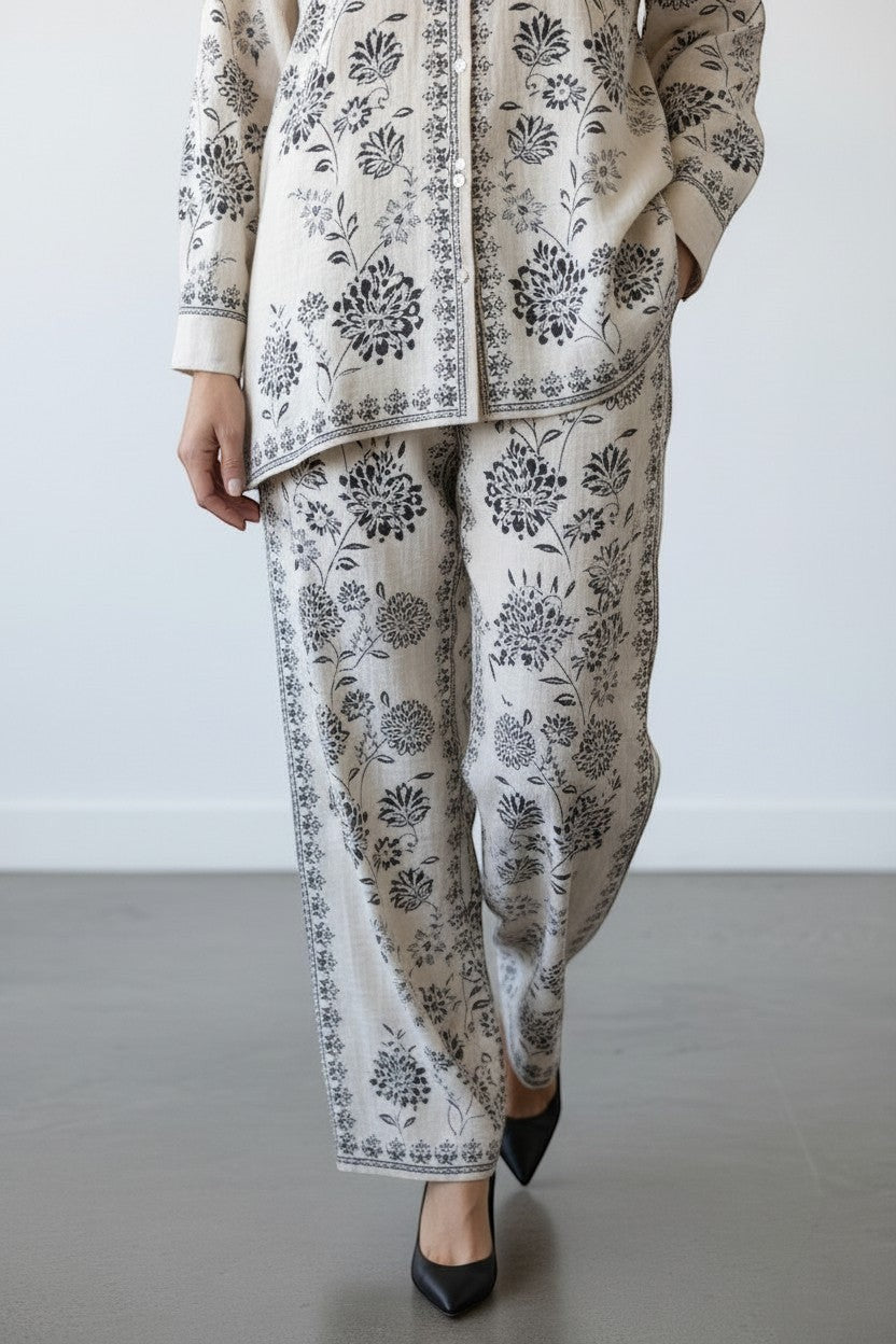 Eclipse The Label ivory and black floral print cotton linen blend co-ord set with collared shirt and straight-leg trousers.